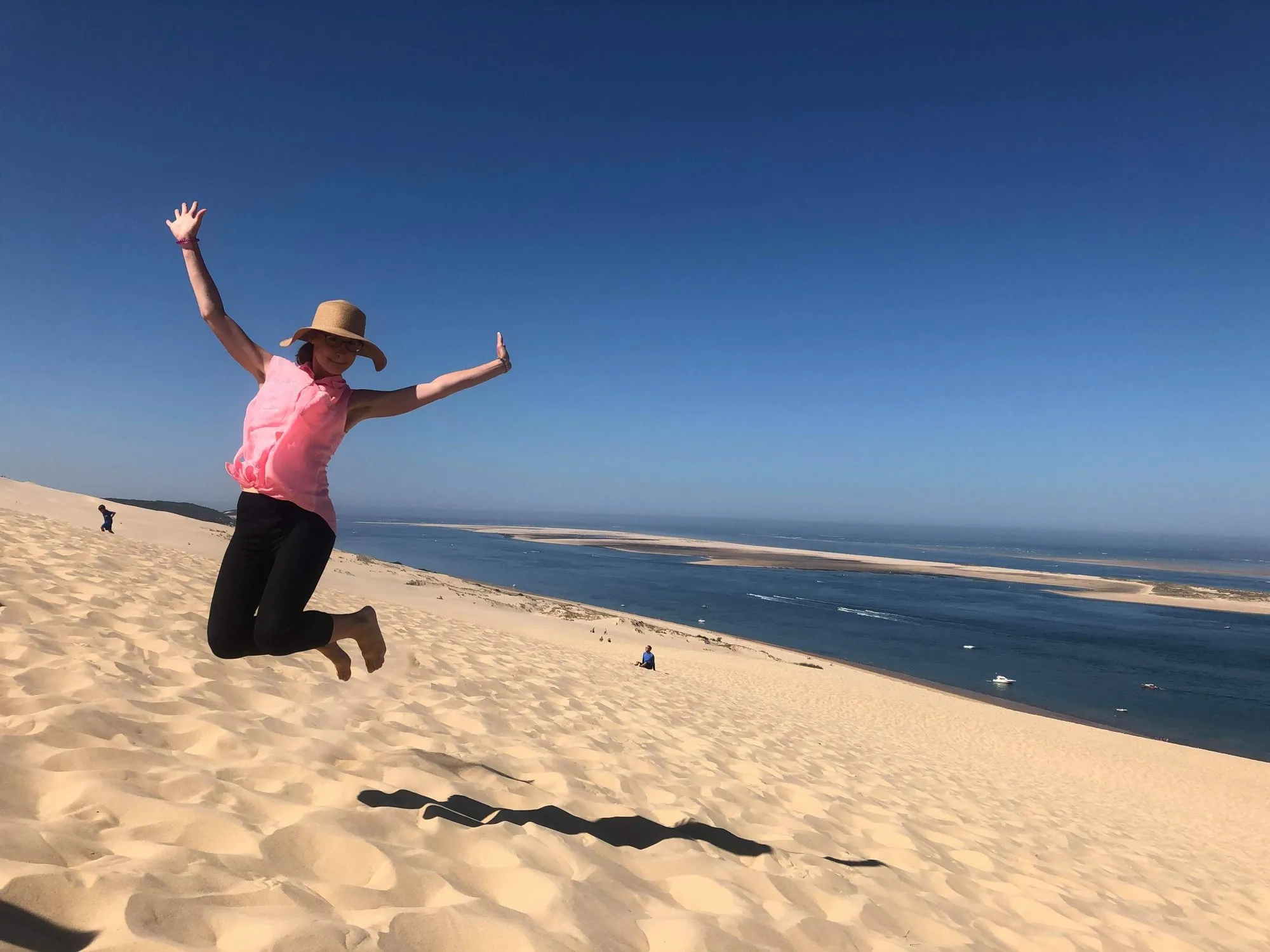 Dune du Pilat u Arcachonu. V roce 2019 jsem podnikla "tour de France" a za měsíc objela Francii, všemi možnými dopravními prostředky mimo jízdní kolo. Na snímku skáču radostí na písečné duně poblíž Bordeaux.
